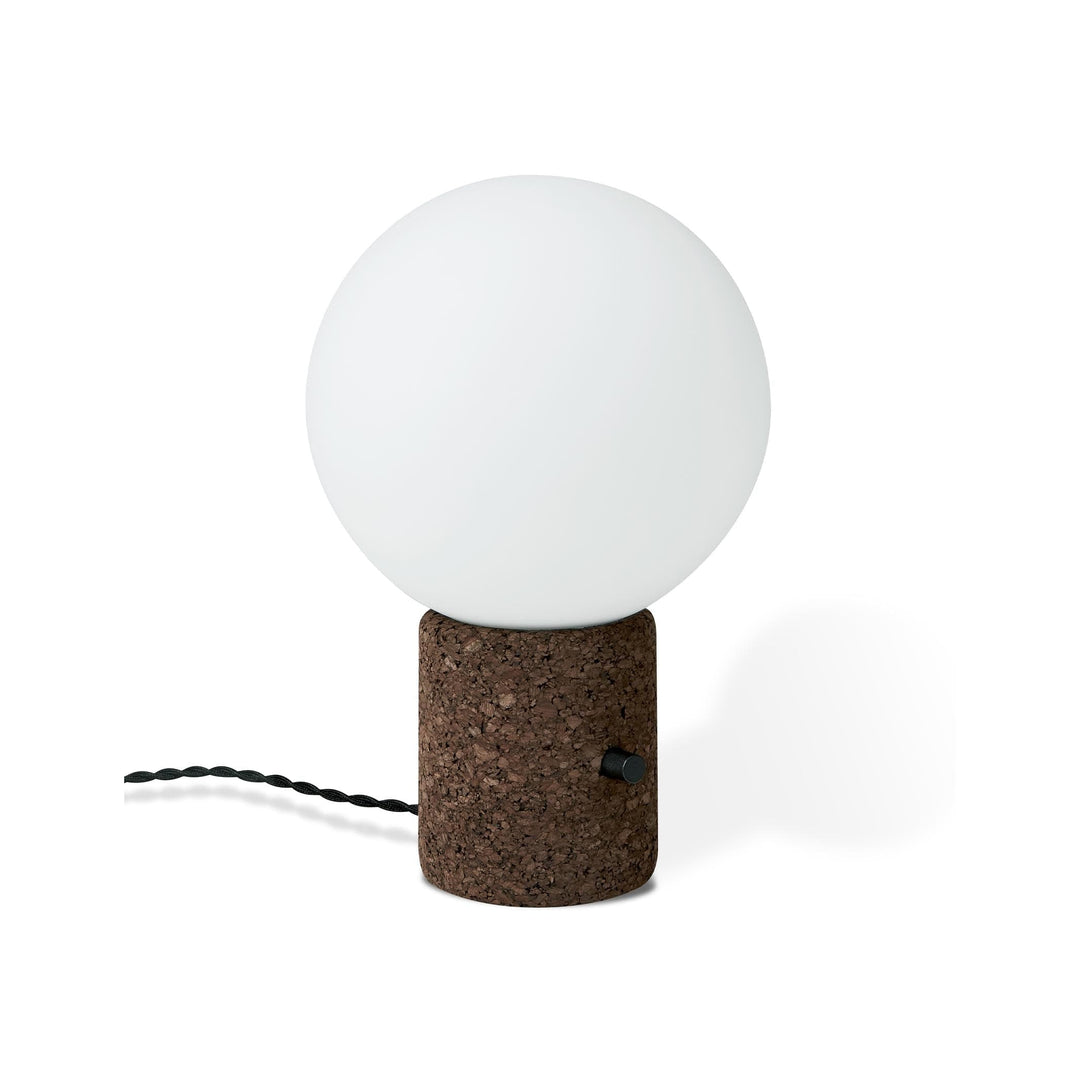 La lampe de table Monocle de Gus* Modern, une pièce captivante qui allie minimalisme et audace, avec un globe élégant et une base en liège.